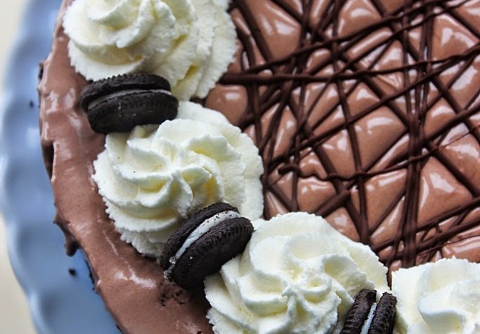 Italian Meringue Cheesecake made with an Oreo cookie crust. Recipe from FlavoursandFrosting.com
