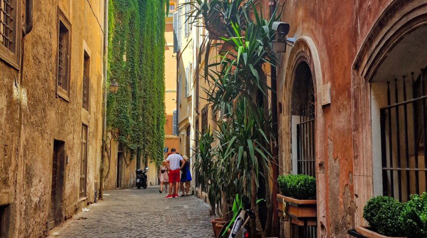 Wandering through the charming back alleys and side streets of Rome on a sunny day. The cobblestone streets and historic buildings frame the scene, capturing the essence of the city's timeless beauty.