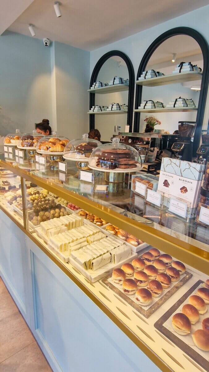 Madrid 101: Everything You Need to Know Before Your Trip Cafe and pastry shop in Madrid with pastel blue branding
