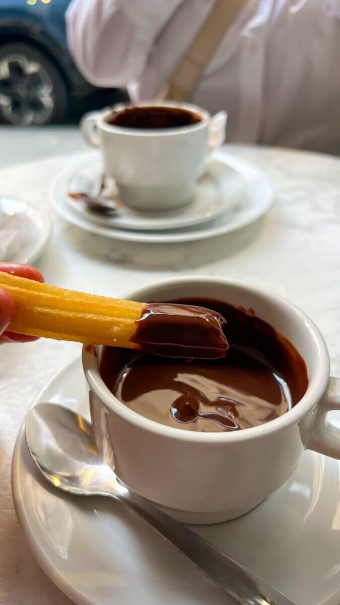 Best Places to eat in Madrid: Breakfast, Brunch, Lunch, Tapas & Dinner Guide Churros and thick dark hot chocolate at an old café in Madrid