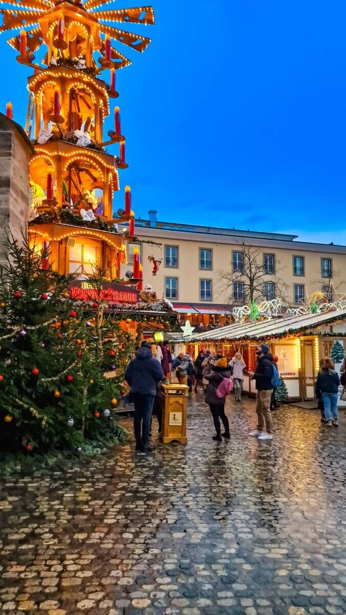 The image captures the festive atmosphere of the Basler Weihnachtsmarkt (Basel Christmas Market) in Basel, Switzerland, a prominent European Christmas market.