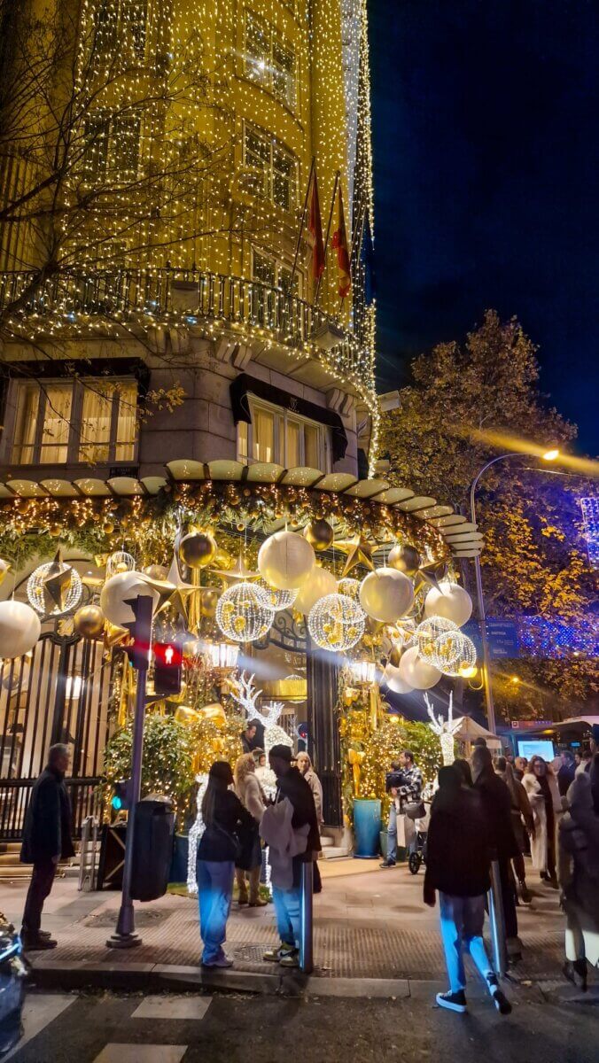 The image captures the festive Christmas lights and decorations in the Wellington Hotel in Madrid, Spain, during the holiday season.