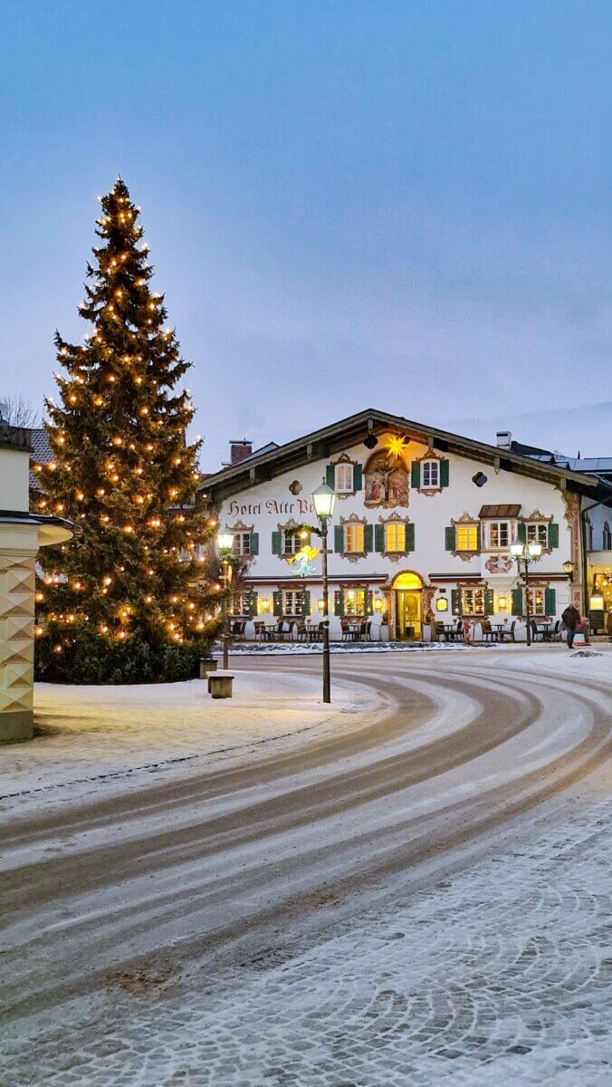 The image shows the Hotel Alte Post, a historic, family-run hotel located in Oberammergau, Bavaria, Germany