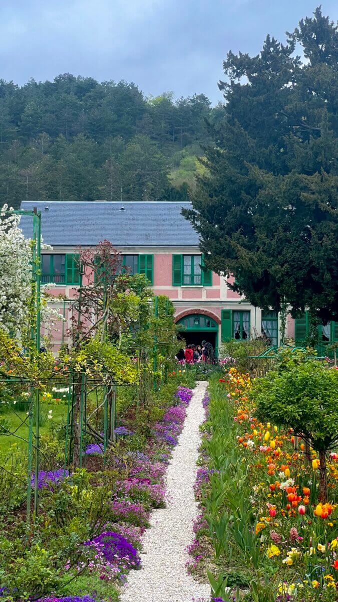 This image shows the Claude Monet Foundation in Giverny, France. The surrounding grounds are the Clos Normand, a vibrant flower garden designed and cultivated by Monet himself.