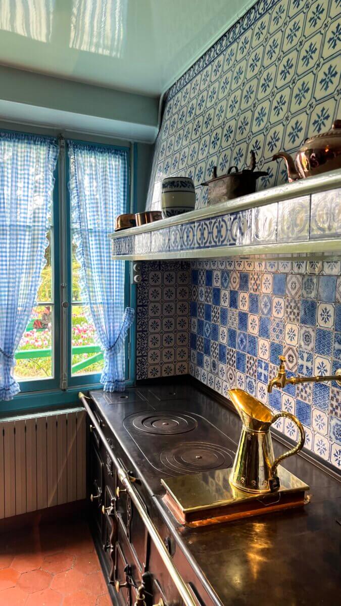 The image depicts the kitchen inside the house of Impressionist painter Claude Monet