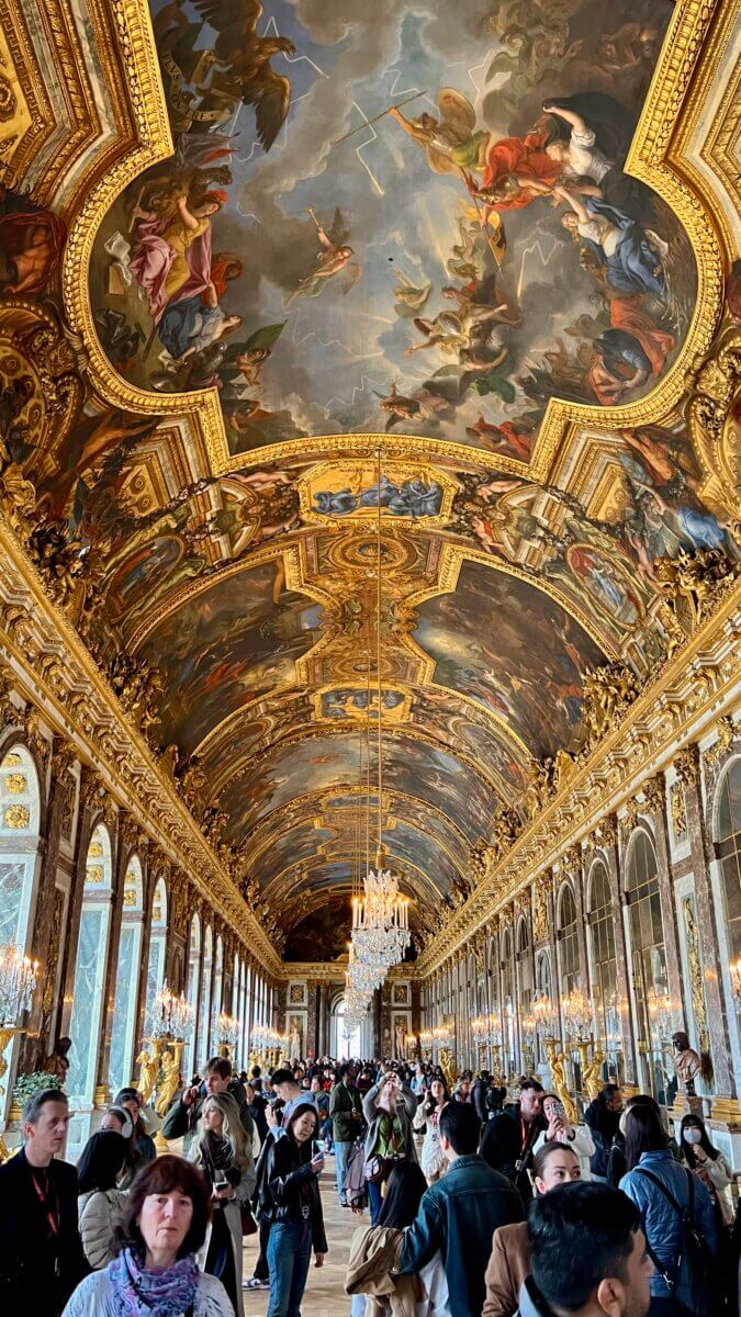 2. This image shows the Hall of Mirrors in the Palace of Versailles, a famous historical landmark located near Paris, France.