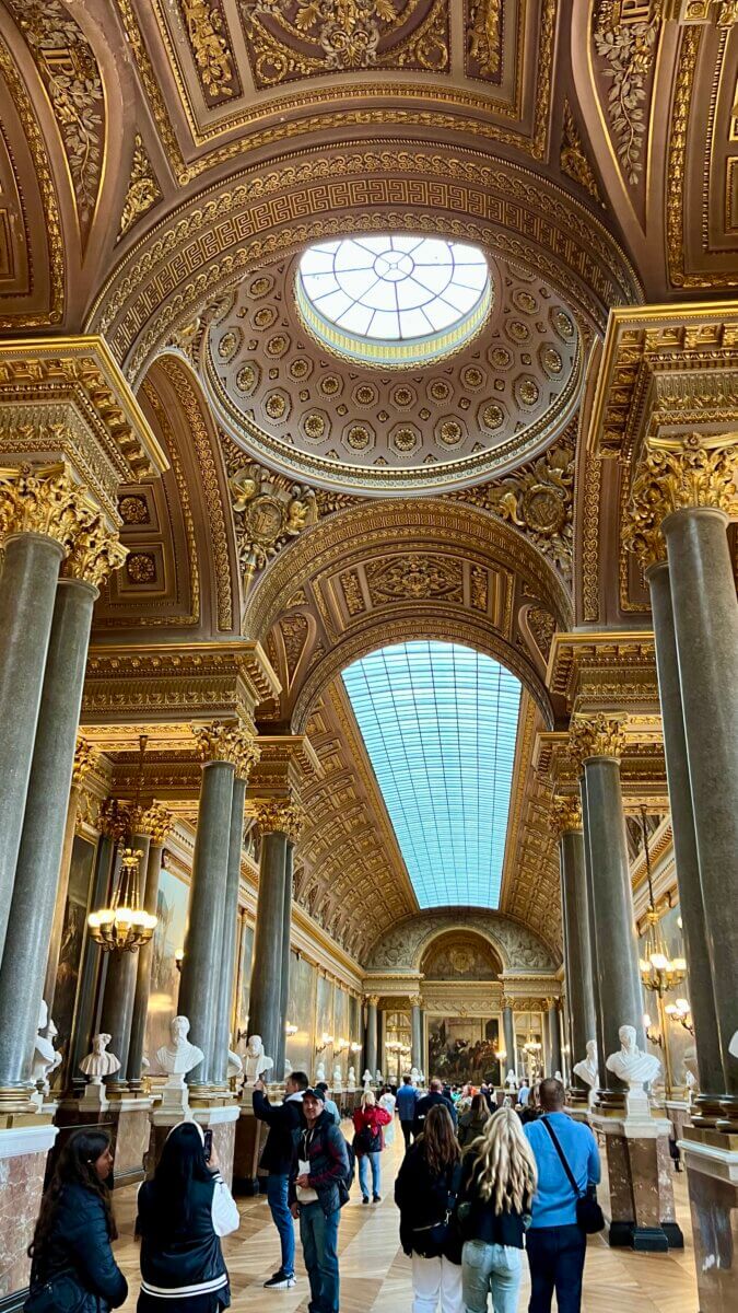 This image captures a moment inside the Galerie des Batailles (Gallery of Battles) at the Palace of Versailles in France