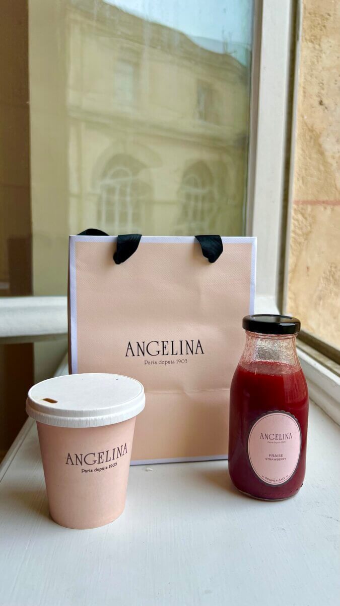7. This item is a curated selection from Angelina Paris, a historic tea house founded in 1903. A bag of croissants, coffee to go and a glass bottle of strawberry juice.