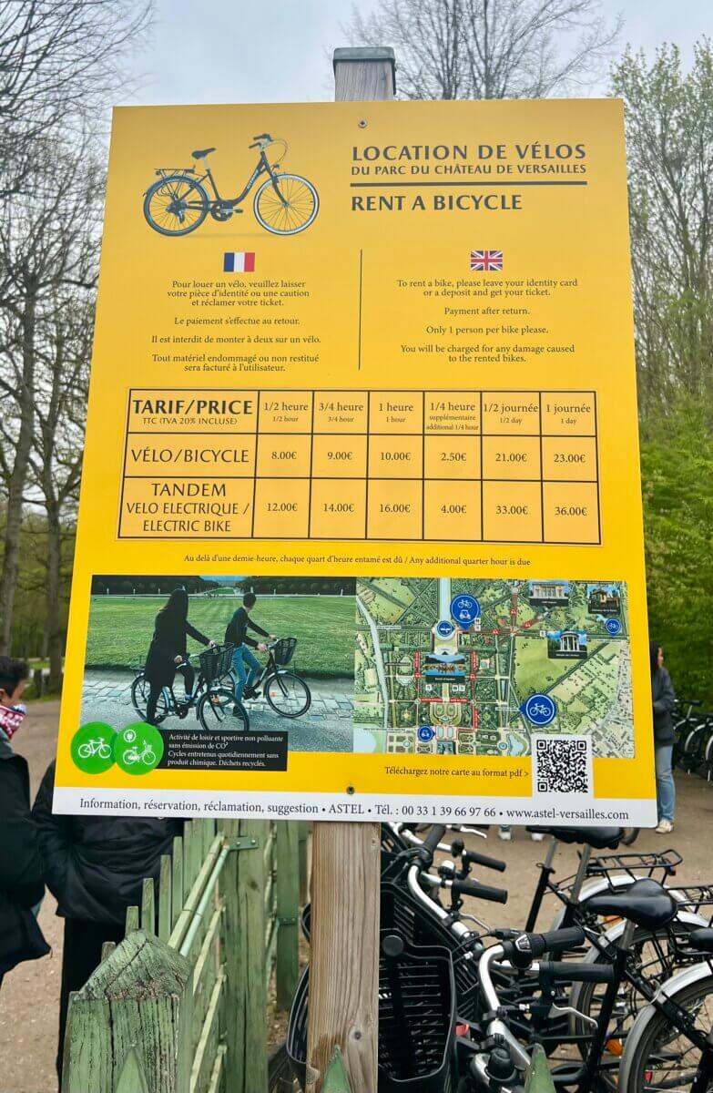 This sign provides information for renting bicycles and electric bikes at the Palace of Versailles