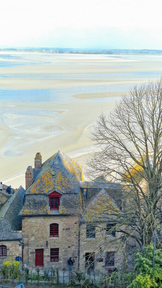 This is a scenic view of the historic Mont-Saint-Michel Abbey and village in Normandy, France