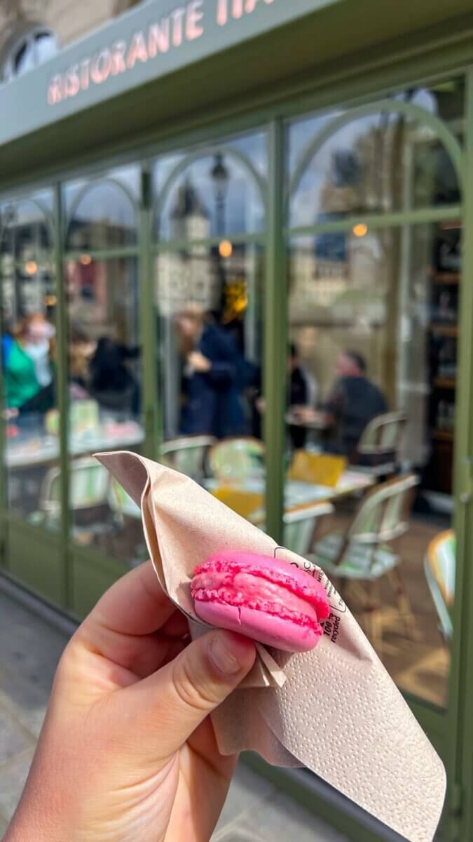 This pink dessert appears to be a Laduree Paris macaron, a French sandwich cookie made with almond flour and egg whites