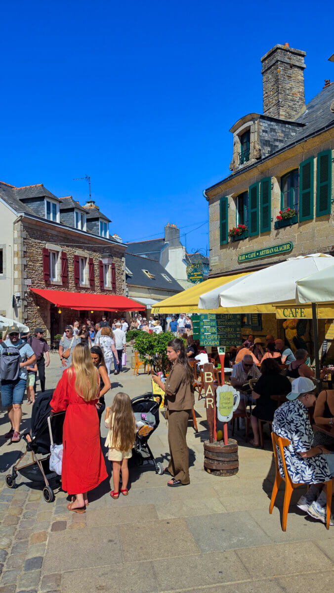 This image captures a vibrant sunny day in the historic walled town of the Ville Close de Concarneau located in the Finistère department of Brittany, France