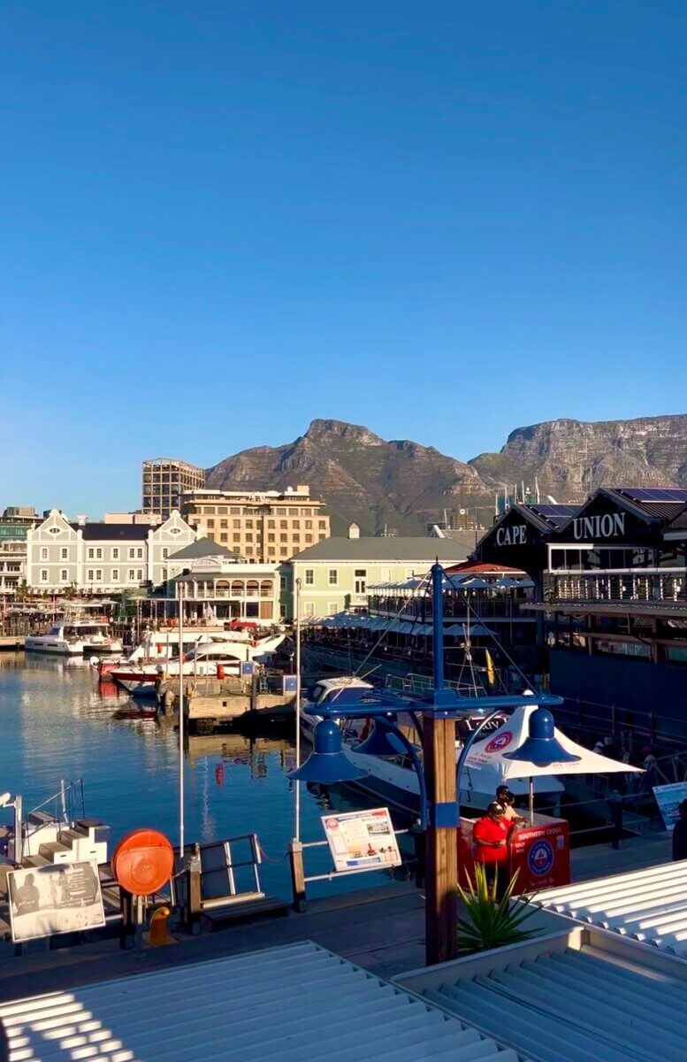 This photo shows the scenic V&A Waterfront harbor in Cape Town, South Africa, with the famous Table Mountainvisible in the background.